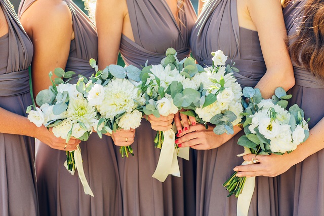 bridesmaids in brown with wedding bouquet